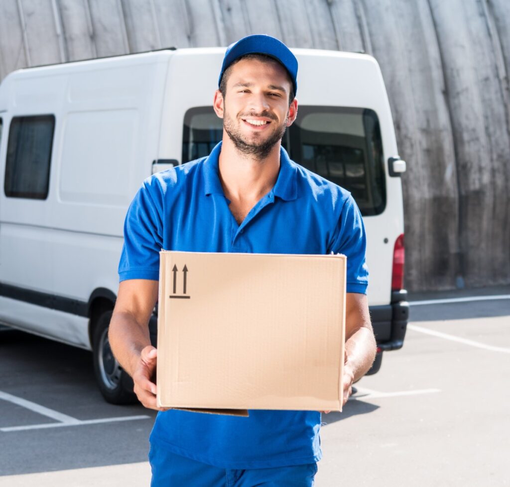 smiling delivery man carrying cardboard box 2024 11 19 00 46 28 utc
